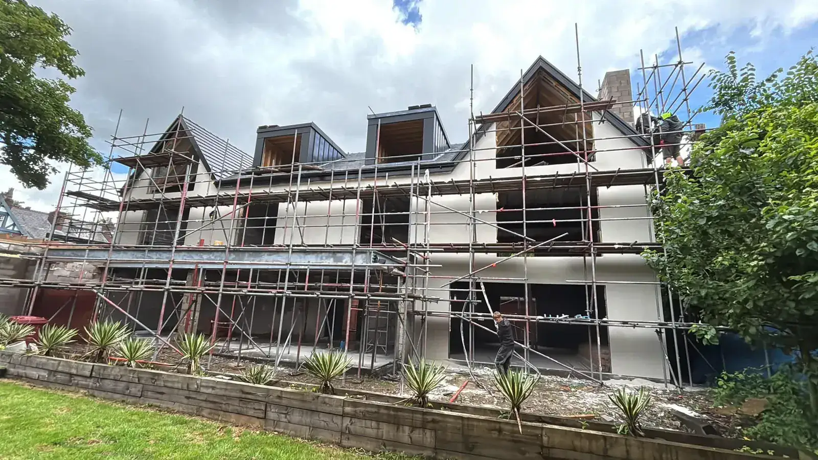 Rendering in progress on the garden elevation of a large detached house