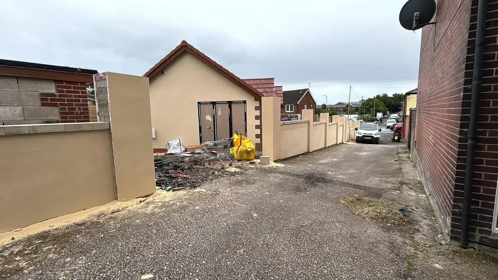 Cream rendered boundary walls and bungalow gable during works